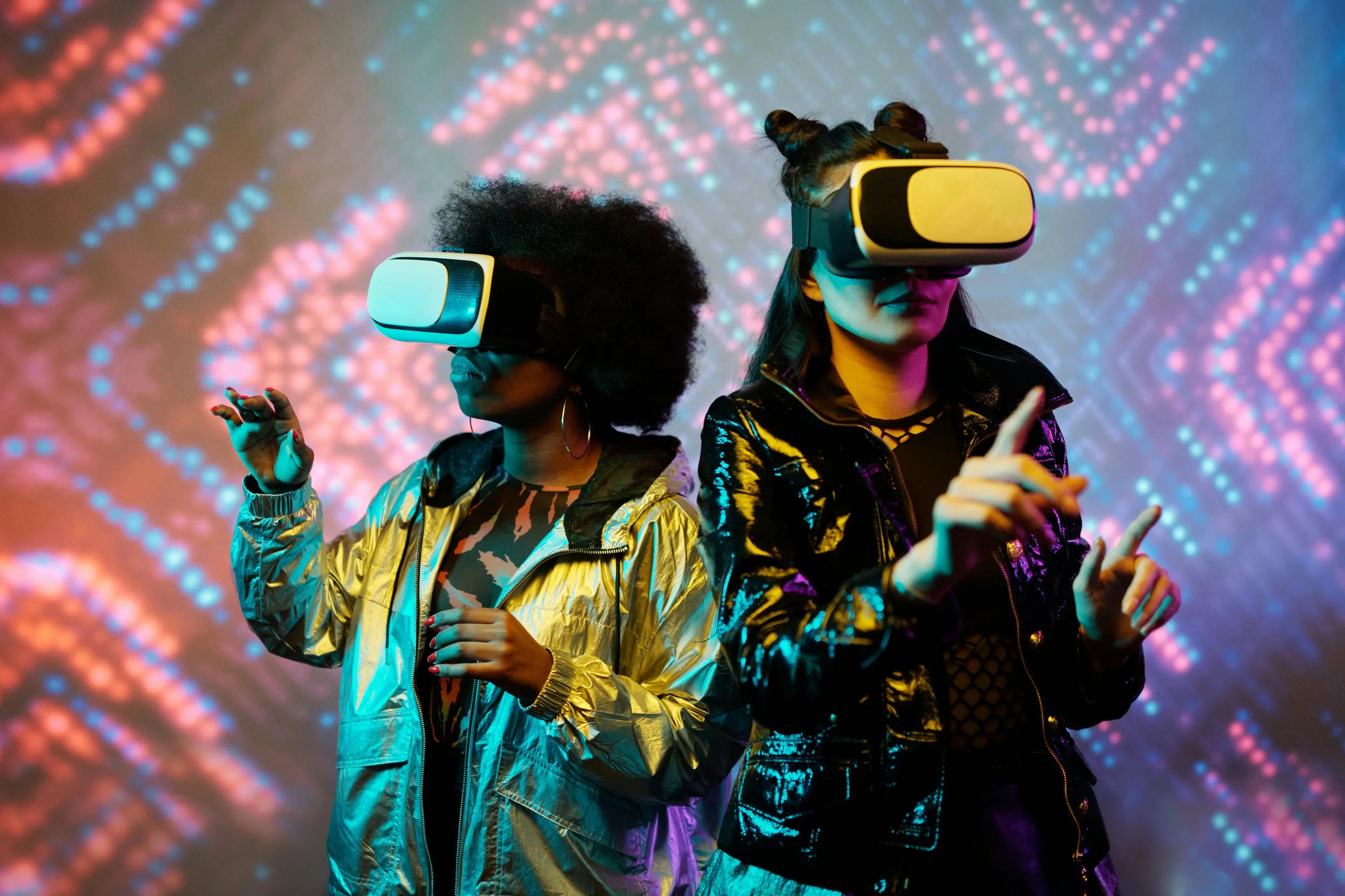 Fashion and video games: two flamboyantly dressed girls with a vr visor